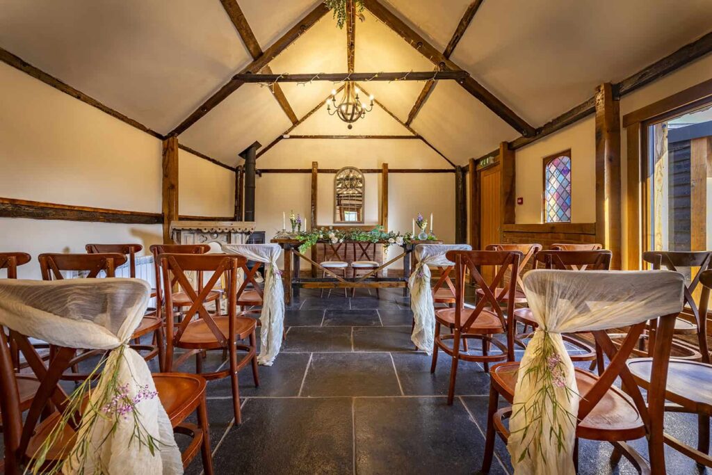 The timber-beamed ceremony room at Coton House Farm wedding venue near Lichfield